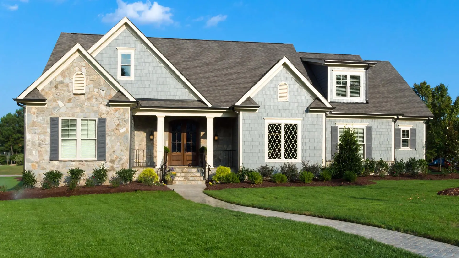 Home front with well-maintained landscaping in Kaukauna, WI.