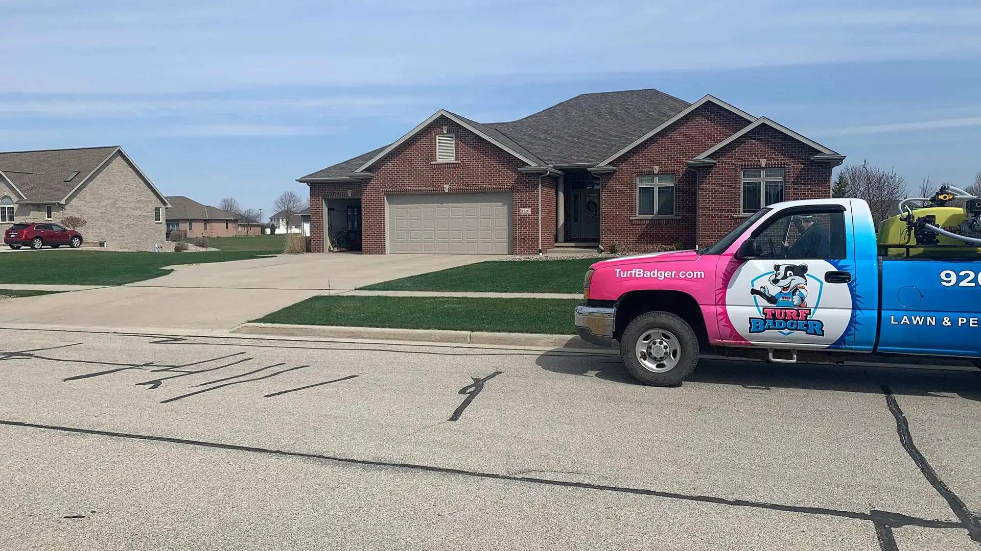 Turf Badger's company truck displayed on street in Greenville, WI.
