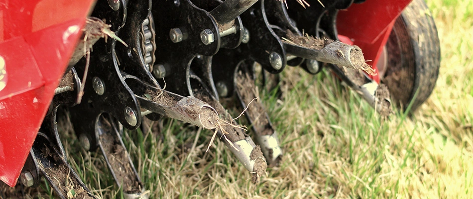 Aerator machine in lawn unplugging cores in Kaukauna, WI.