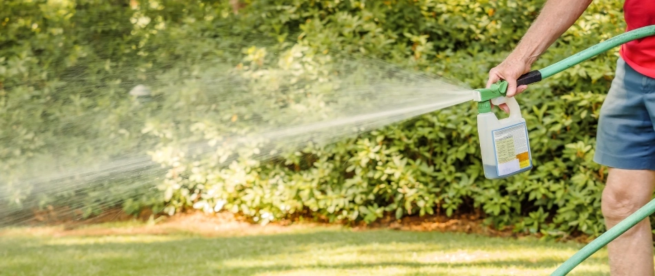 Professional applying liquid aeration treatment to lawn in Pittsfield, WI.