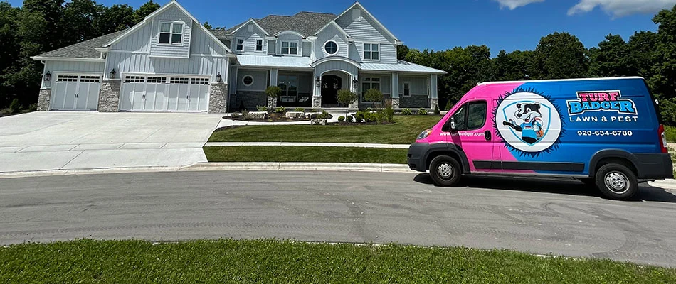 Turf Badger service van in front of a home with a healthy lawn near Appleton, WI.