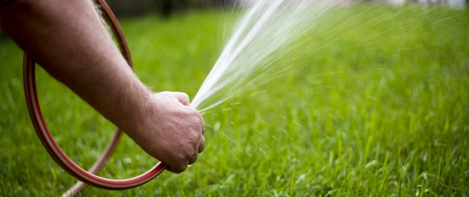Home owner watering their lawn in Escanaba, MI.