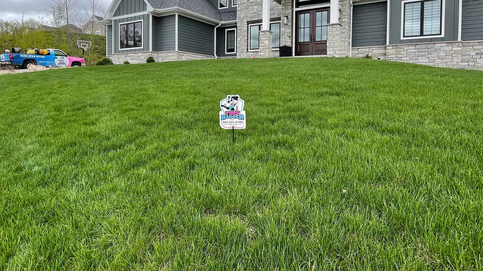 Turf Badger work truck at an Appleton, WI home after lawn care services.