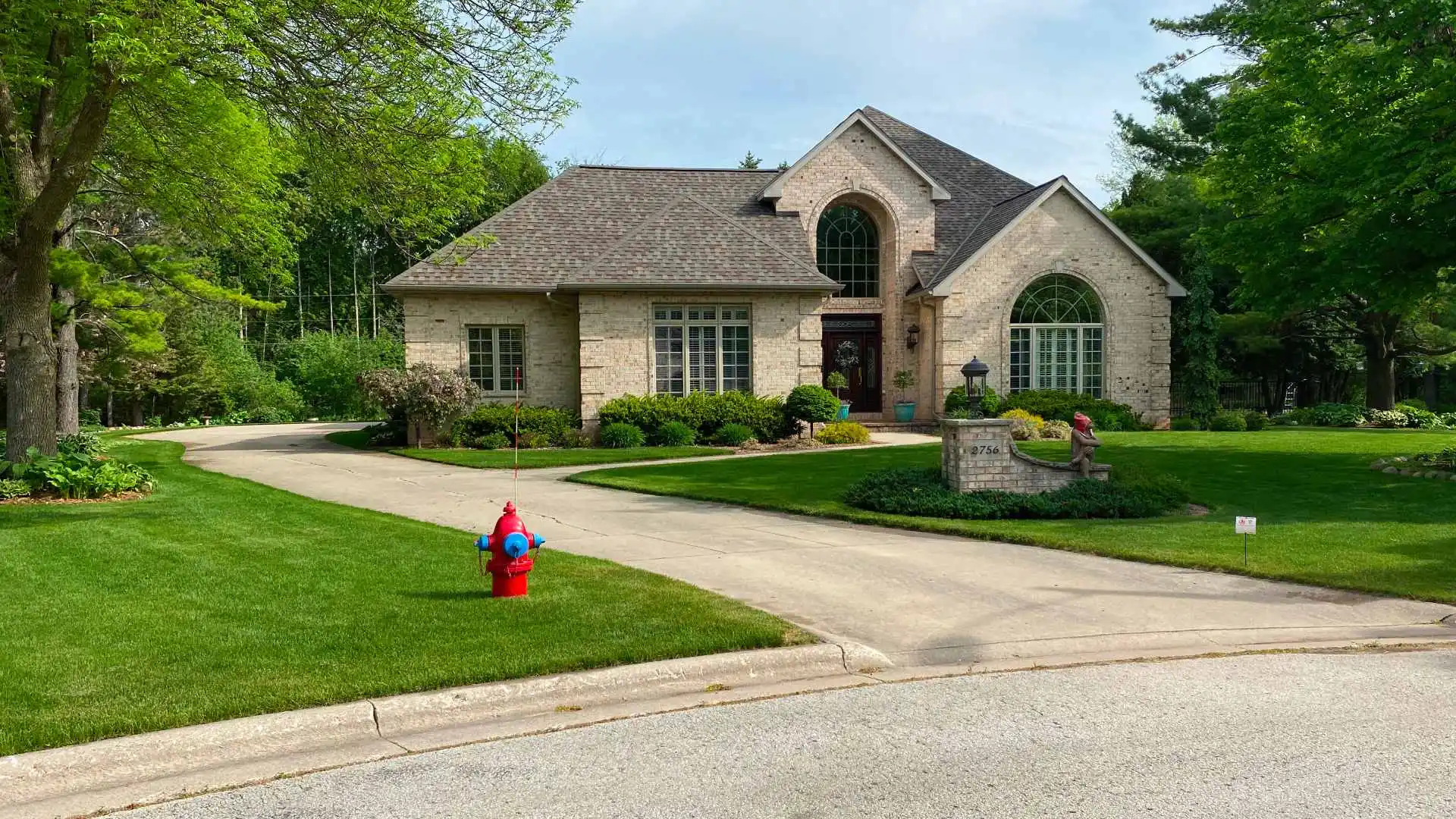 Maintained lawn in front of beautiful home in Iron Mountain, MI.