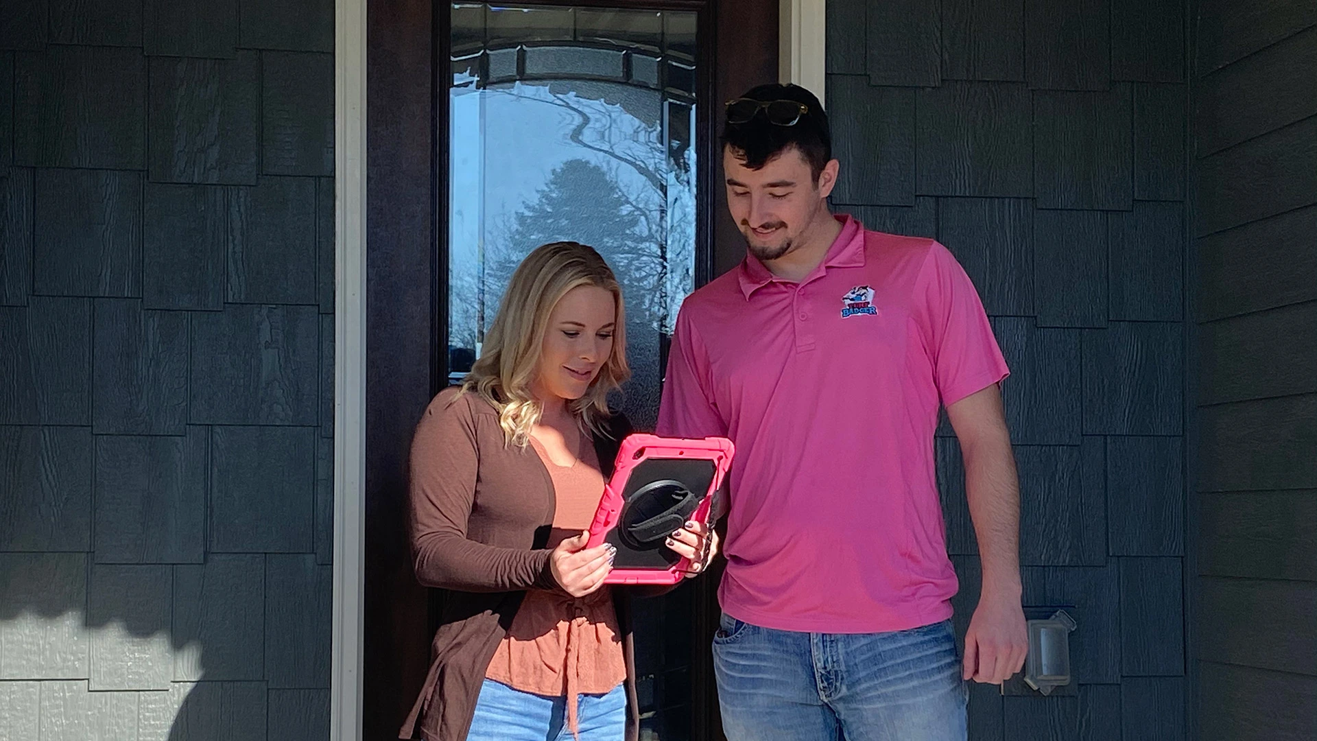Our specialist with a client looking at information on an Ipad in Green Bay, WI.