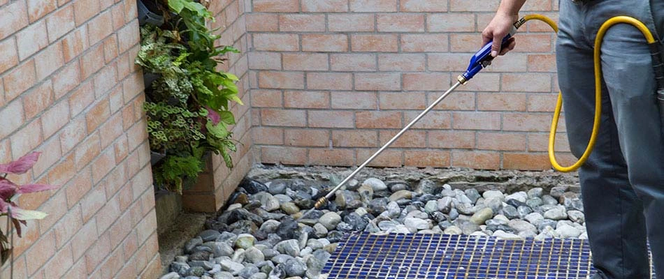 Our landscaper performing perimeter pest control for a home in De Pere, WI.