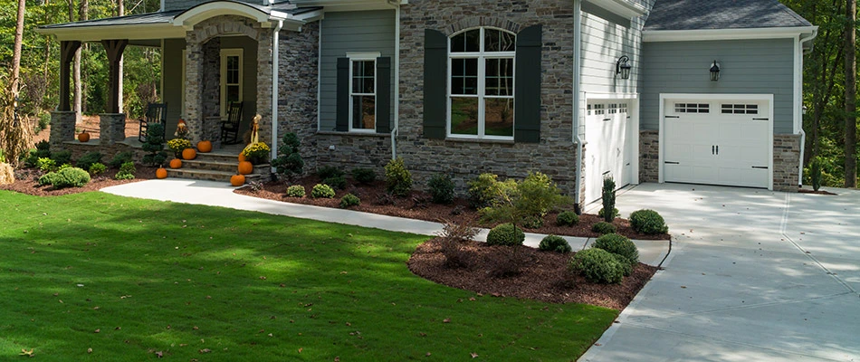 A home with clean landscaping decorated for fall in Bellevue, WI.