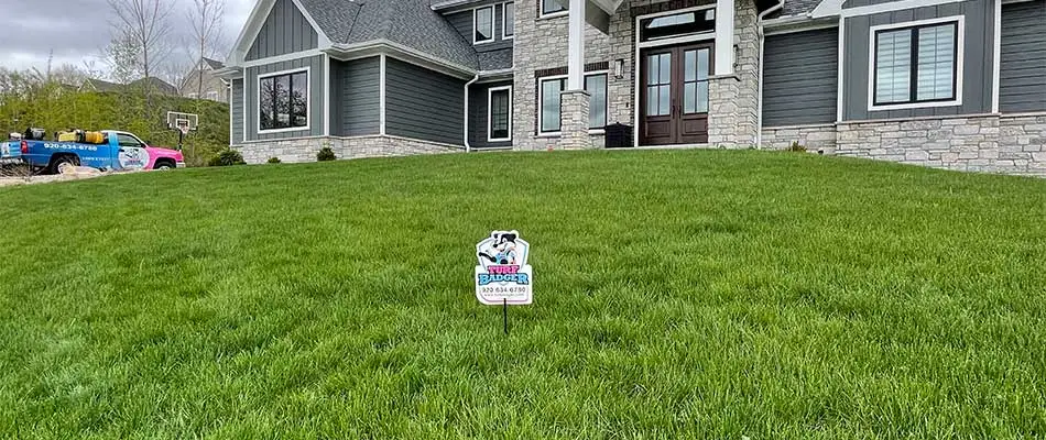 Healthy home lawn and Turf Badger sign near Ashwaubenon, WI.